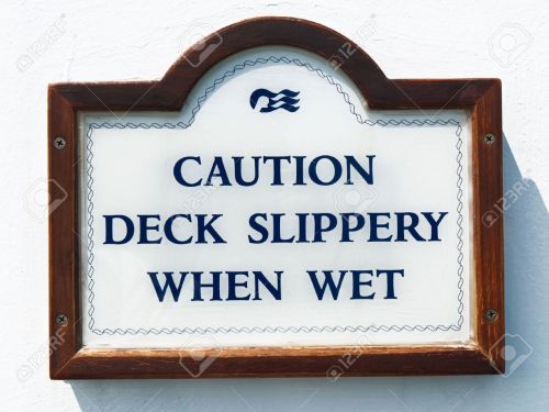 13727196-sign-for-slippery-deck-on-the-cruise-boat-Stock-Photo